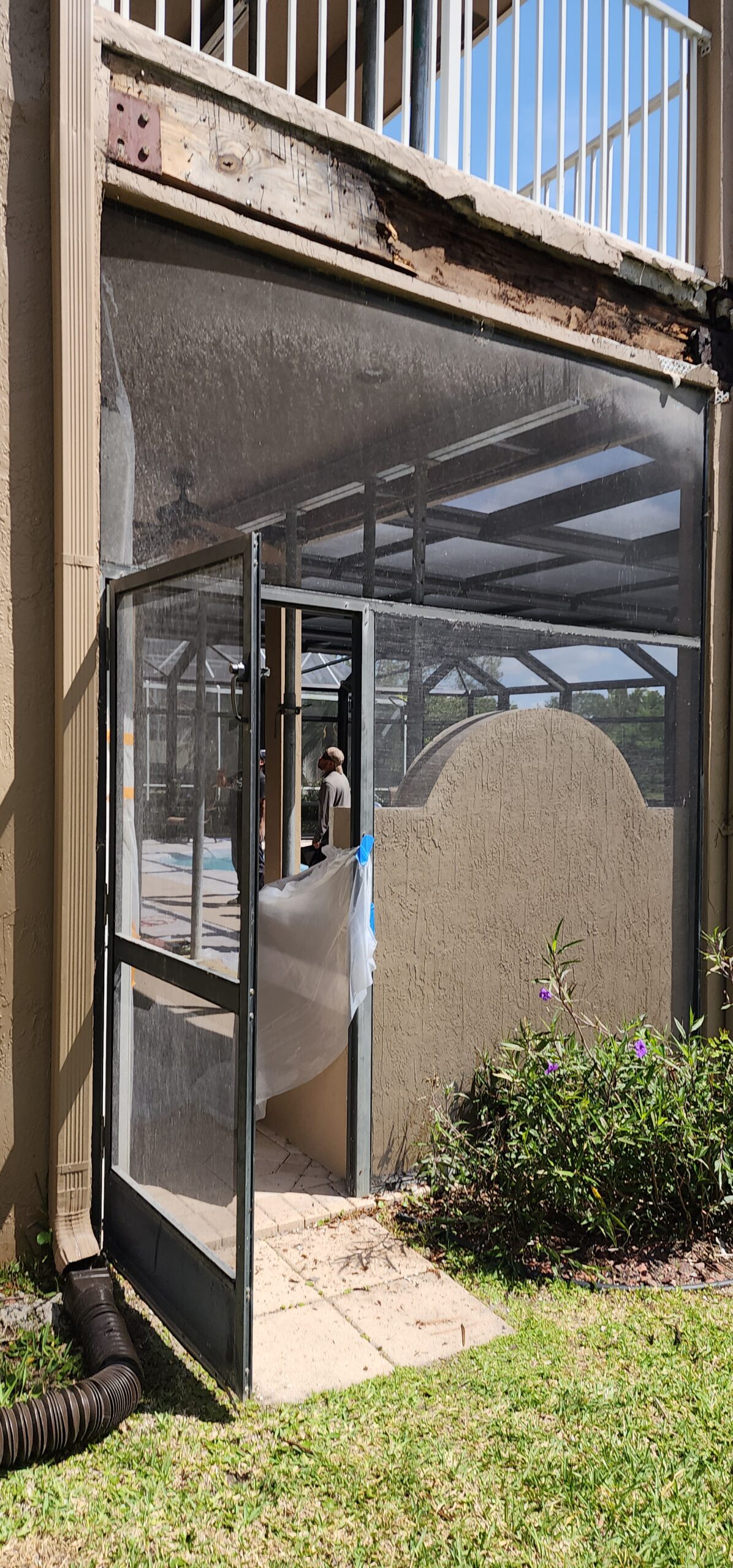 Balcony repair nearing completion with stucco refinished over reinforced steel.