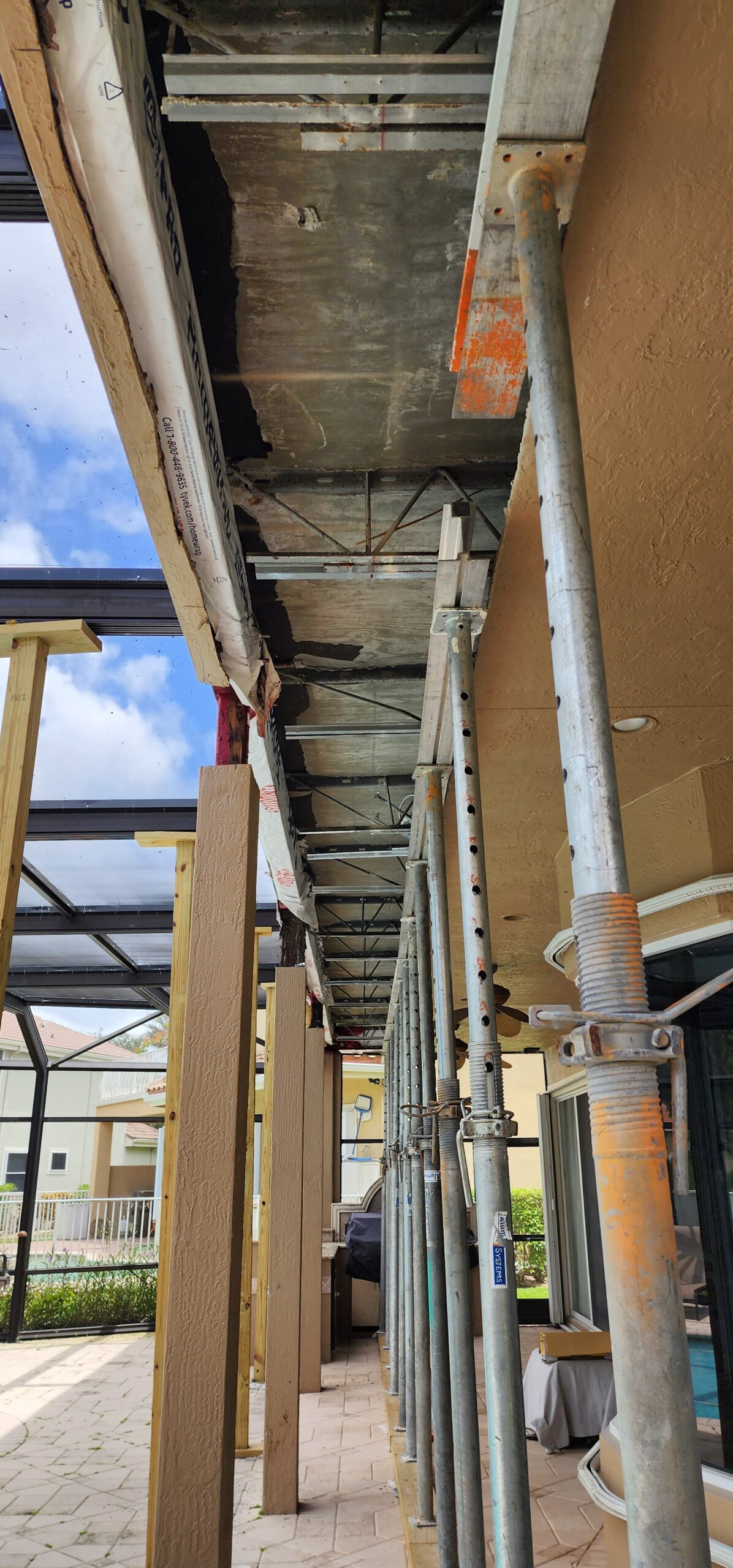 Balcony repair with exposed steel reinforcement under structural engineer–designed repair detail.