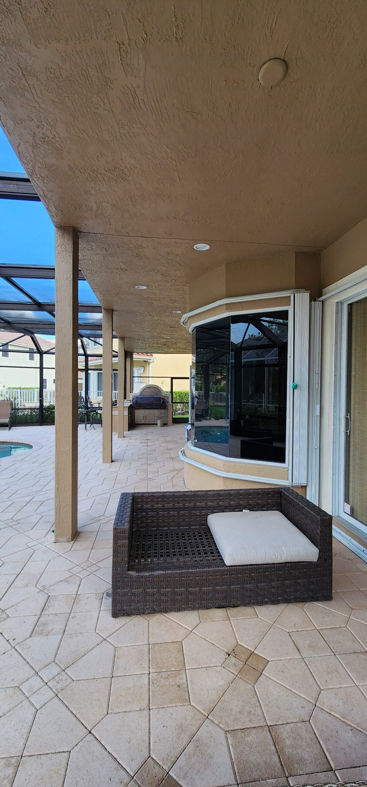 Balcony repair progress showing treated steel reinforcement and re-formed stucco areas.