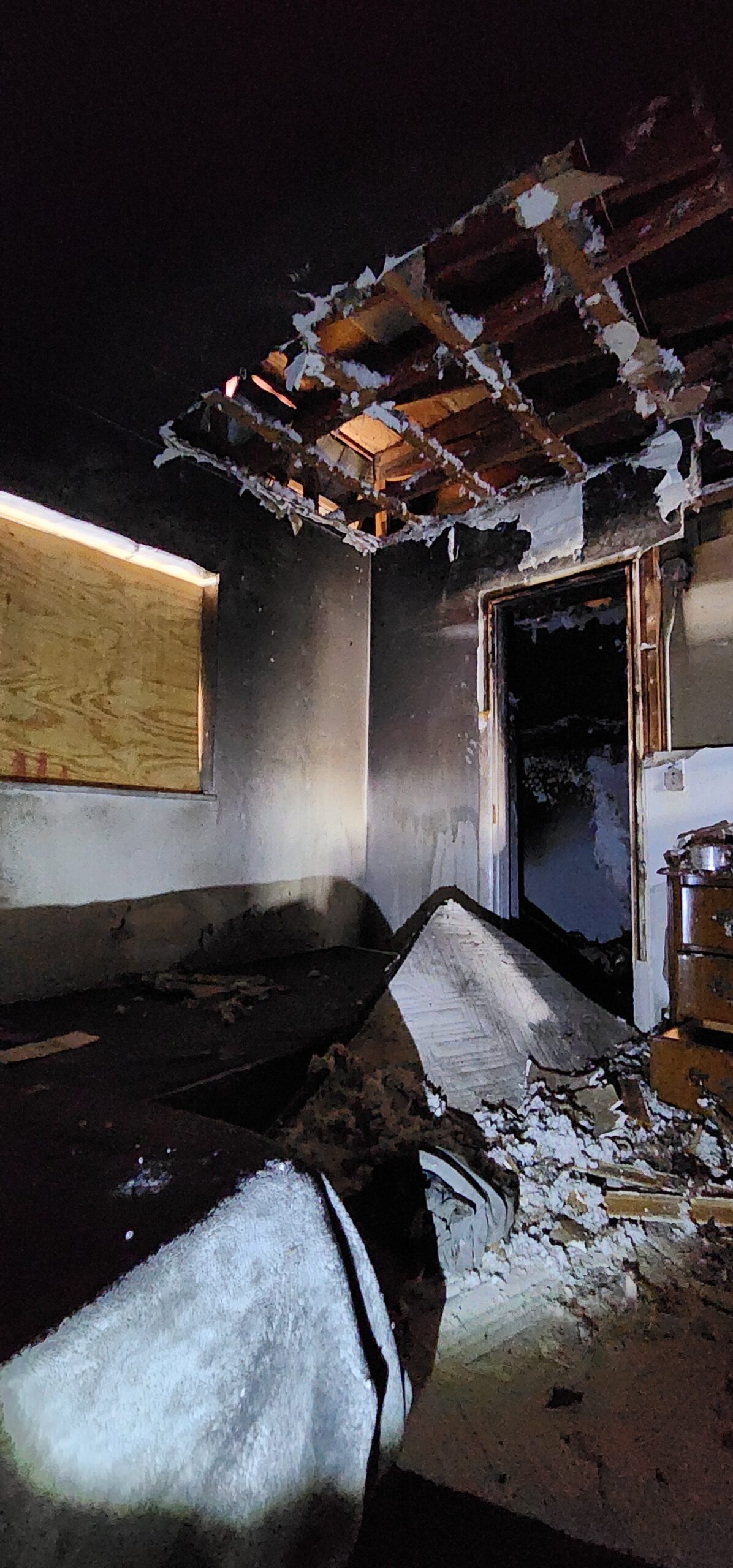 Interior of apartment unit with severe fire and smoke damage.